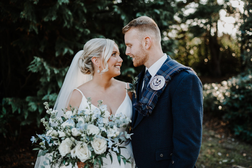 newly wed couple look lovingly into each others eyes at Lochgreen Glasshouse 